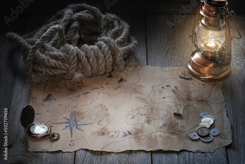 Vintage map and treasure hunting and travel accessories, table in captain's cabin, Columbus day background
