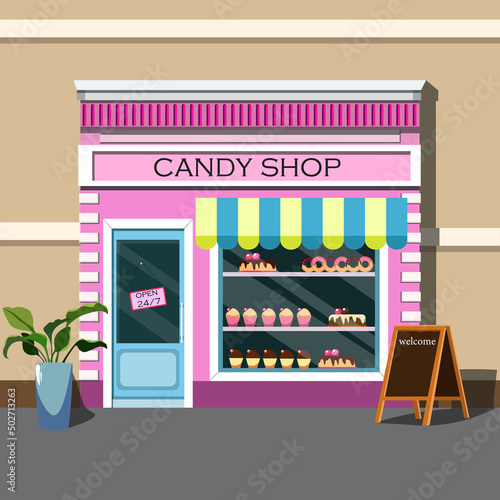 facade of a pink candy store with an attractive showcase with pastries