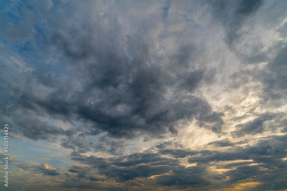 Dark gloomy clouds on a stormy sky. Natural atmospheric background. Dark gloomy clouds on a stormy sky. Natural atmospheric background.