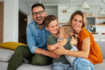 Happy family having fun time at home. Parents playing smiling with childrens together.