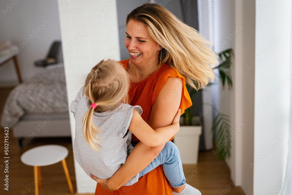 Happy loving family. Mother and her daughter child girl playing and hugging together at home Happy loving family. Mother and her daughter child girl playing and hugging together at home