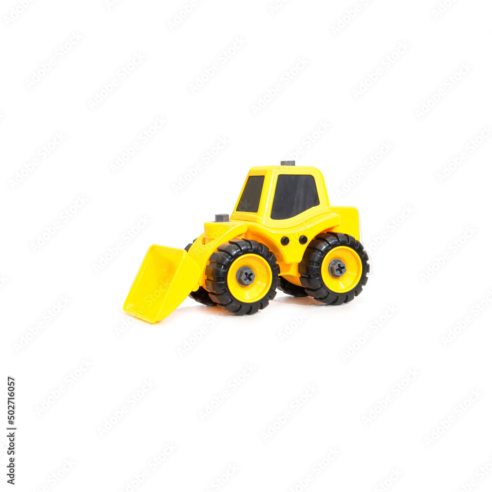 Children's toy tractor yellow with a blade on a white background Children's toy tractor yellow with a blade on a white background