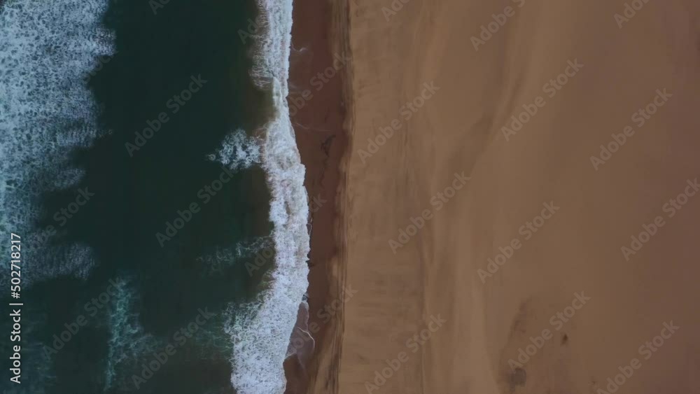 Birds eye drone shot of Sandwich Harbour in Namibia - drone is following the coastline where desert meets the ocean. Snippet could ideally be used for travel related videos or a Namibia movie. Birds eye drone shot of Sandwich Harbour in Namibia - drone is following the coastline where desert meets the ocean. Snippet could ideally be used for travel related videos or a Namibia movie.