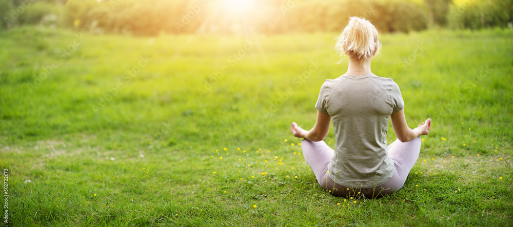 © candy1812 - Woman sitting in active wear in lotus position in nature. © candy1812 - Woman sitting in active wear in lotus position in nature.
