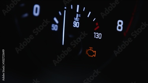 Real car temperature gauge. White gauges over black background. Check your engine concept. High quality photo