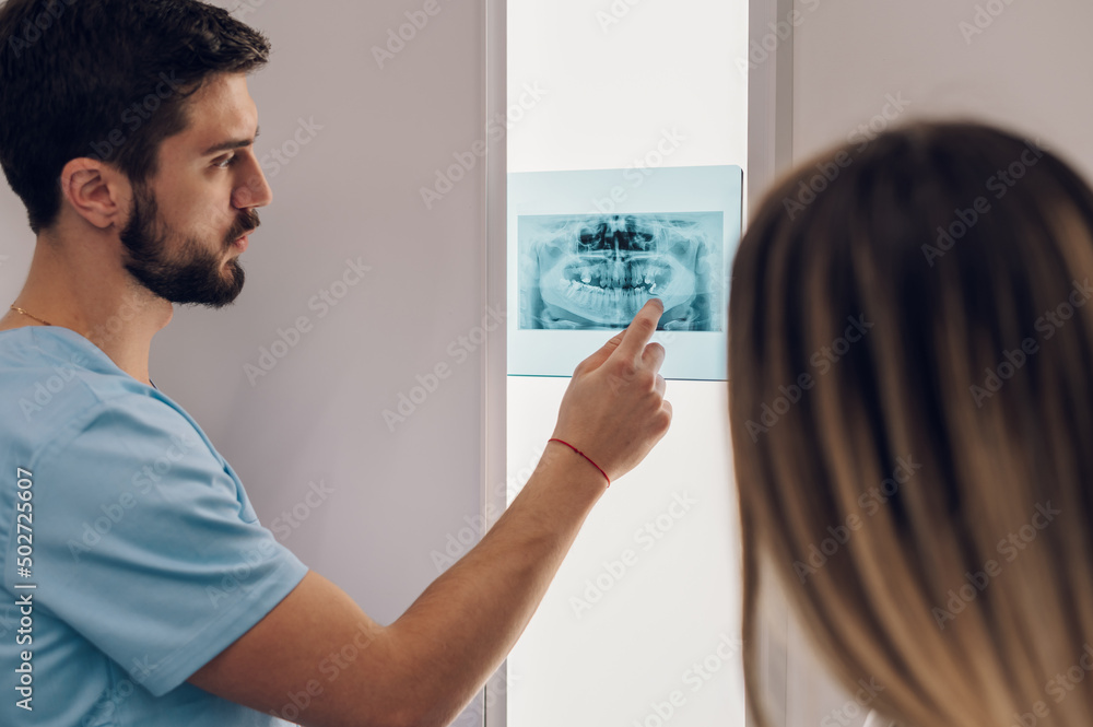 Group of doctors looking at x-ray image from jaw Group of doctors looking at x-ray image from jaw