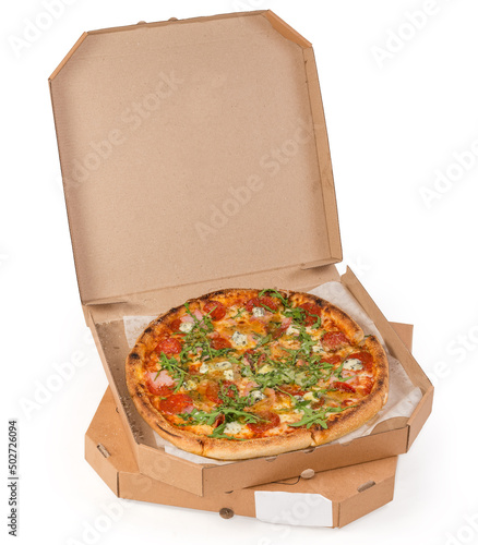 Round pizza with salami in the open cardboard box