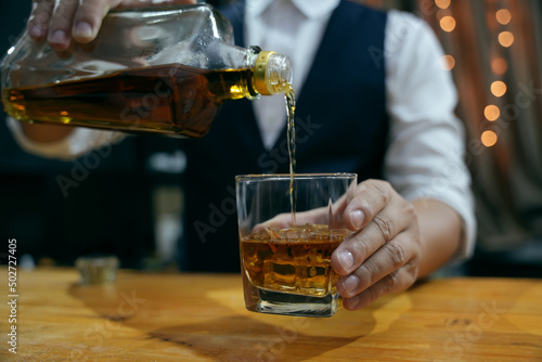 Barman pouring whiskey whiskey glass beautiful night