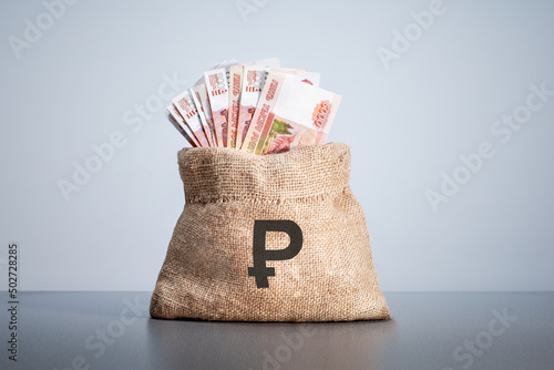 Money bag on which rubles sign. Rubles banknotes. Cash money. photo
