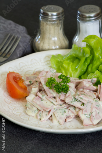 cervelas salad in a plate on a table photo