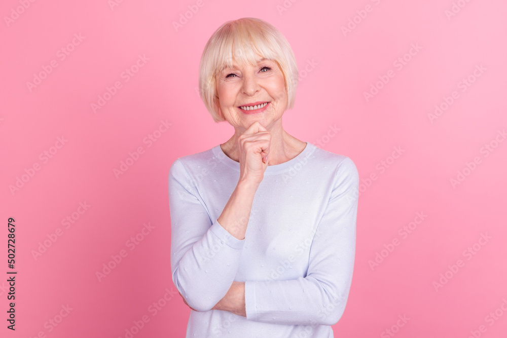 Photo of senior cheerful woman good mood hand touch chin confident think smart isolated over pink color background Photo of senior cheerful woman good mood hand touch chin confident think smart isolated over pink color background