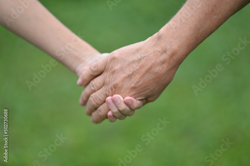 senior woman and child holding hands