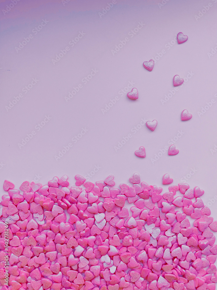 Fototapeta premium textured background, lots of small decorative candy pink hearts