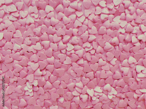 textured background, lots of small decorative candy pink hearts