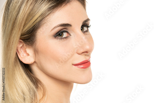 portrait of a young smiling woman with a humpbacked nose on a white background