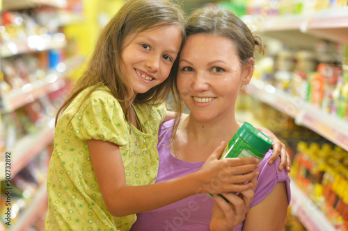 Portrait of mother and daughter choosing products