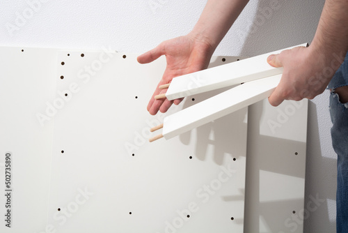 Assembly cabinet furniture. Do it youself concept. White chipboard interior photo