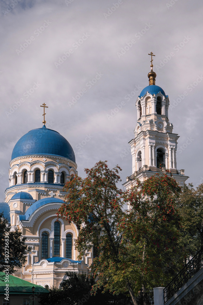 Uspensky cathedral and bell tower of Uspenskaya Tikhonova Pustyn on sunny summer day. Leo Tolstoy village, Kaluga Oblast, Russia.