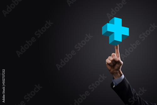 Businessman hold 3D plus icon, man hold in hand offer positive thing such as profit, benefits, development, CSR represented by plus sign.The hand shows the plus sign