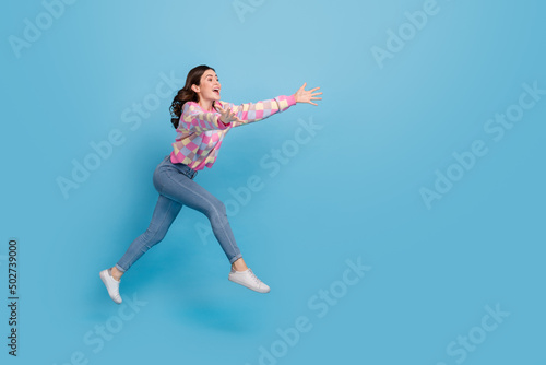 Wallpaper Mural Full size profile side photo of young cheerful girl hurry run open hands jump isolated over blue color background Torontodigital.ca