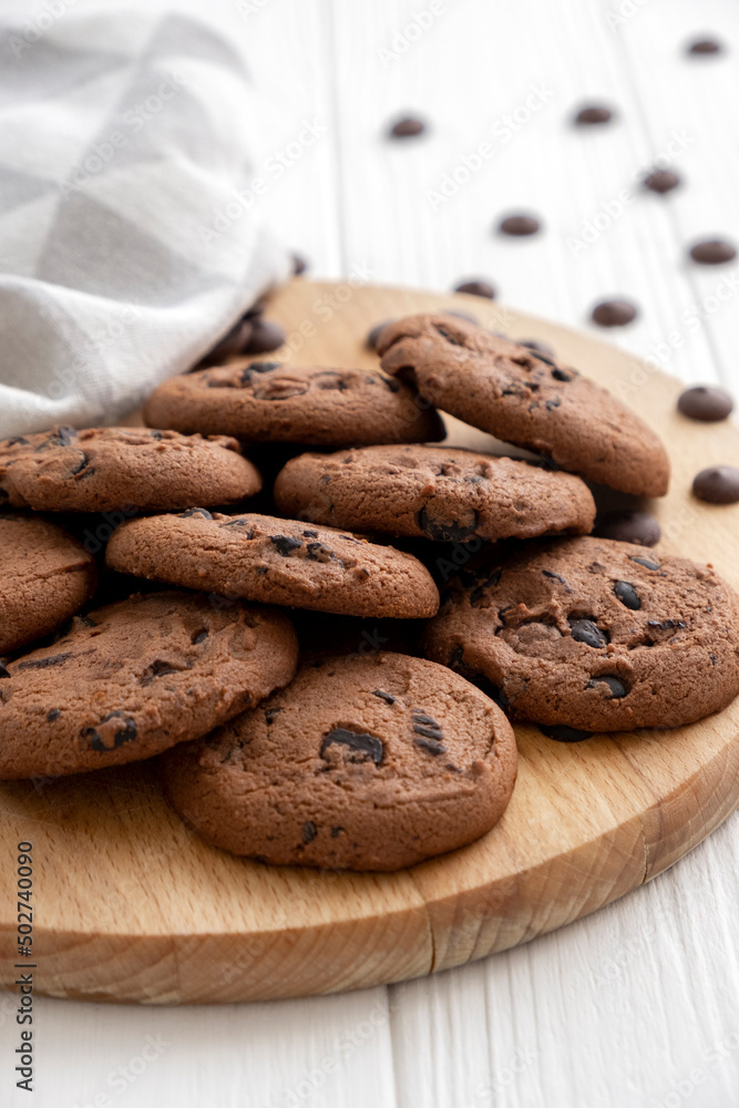 Homemade chocolate chip cookies on wooden board with kitchen towel. Recipe of traditional pastry for tea, freshly baked cookies with pieces of chocolate. Homemade chocolate chip cookies on wooden board with kitchen towel. Recipe of traditional pastry for tea, freshly baked cookies with pieces of chocolate.