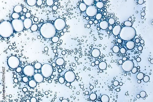 Oxygen bubbles in liquid skincare gel serum macro texture background top view