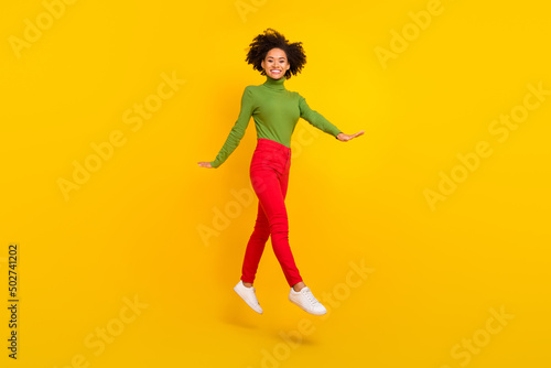 Full body profile side photo of young cheerful girl jump dream travel isolated over yellow color background