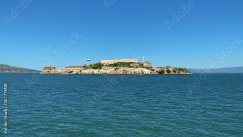 Wide shot pov from sailing boat showing famous Alcatraz Island Prison during sunny day