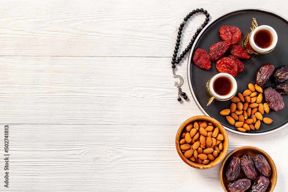 Ramadan holyday table with dates fruits and islamic rosary with star and crescent Ramadan holyday table with dates fruits and islamic rosary with star and crescent