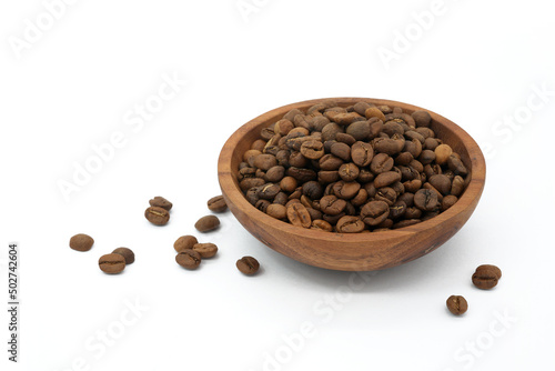 Coffee beans in wooden bowl isolated on white background