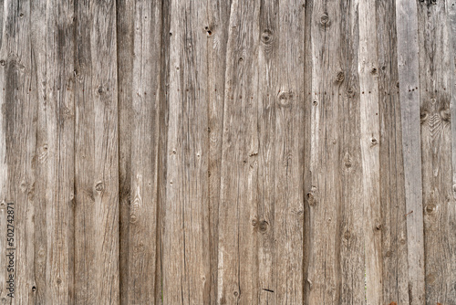 Vintage fence of old wooden boards. Texture of an aging wooden surface. Beautiful wooden background. © sandipruel
