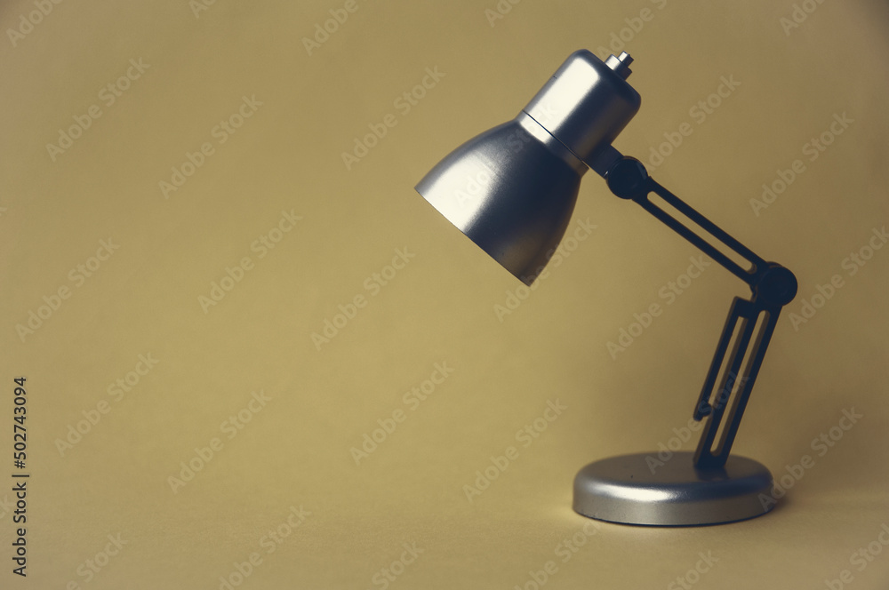 Closeup silver and black small lamp with vintage color background. Copy space concept