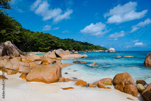 Praslin Seychelles tropical island with withe beaches and palm trees, Anse Lazio beach,Palm tree stands over deserted tropical island dream beach in Anse Lazio, Seychelles.  © Fokke Baarssen