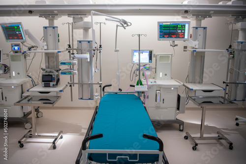 Empty Modern technology in intensive care unit room with different equipment and devices, beds and pillows.