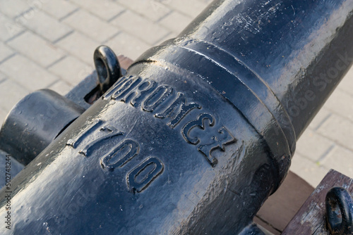 Tela Black iron replica cannon from battleship Goto Predestination on Admiralteyskaya Square with title Voronezh 1700