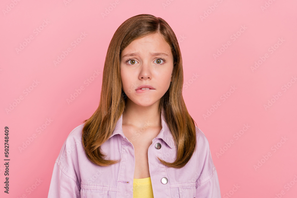 Photo of young girl bite lips worried nervous afraid fail trouble isolated over pink color background Photo of young girl bite lips worried nervous afraid fail trouble isolated over pink color background