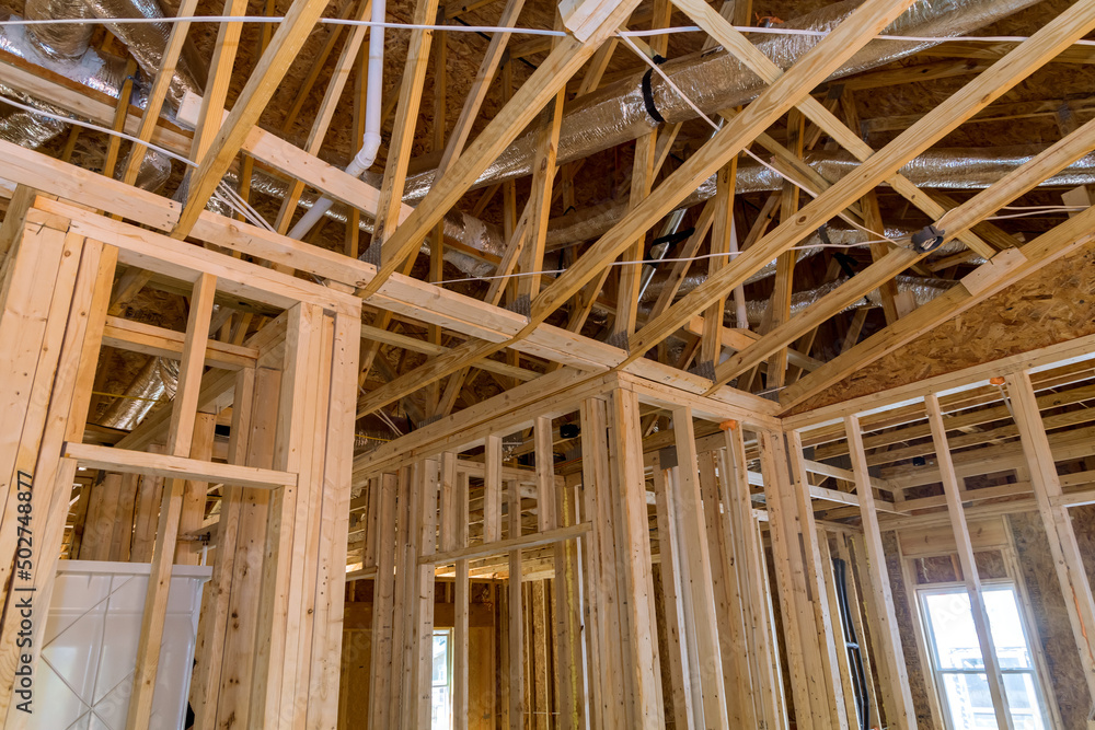 Framing of wood framework a new wooden house under construction Framing of wood framework a new wooden house under construction