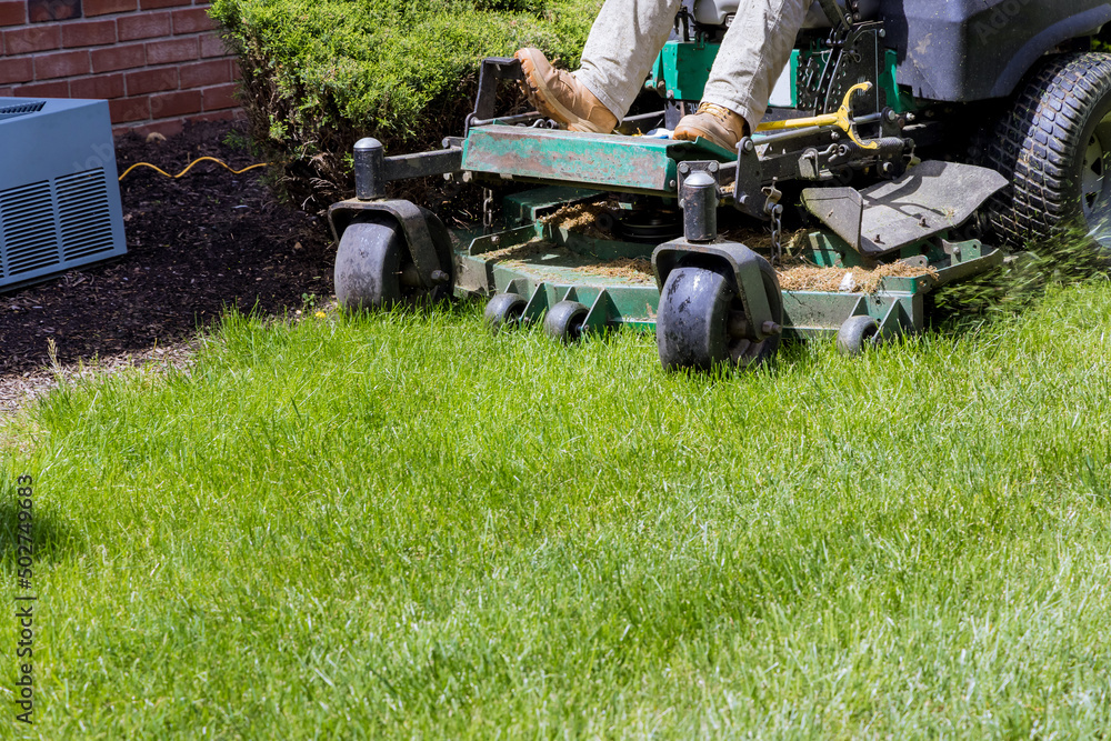 Man mows lawn using gasoline-powered self-propelled lawn mower on cutting grass with lawn mower. Man mows lawn using gasoline-powered self-propelled lawn mower on cutting grass with lawn mower.