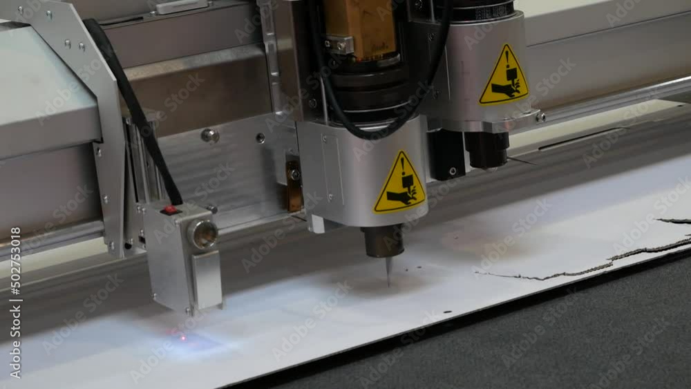 The cutting plotter cuts the cardboard packaging The cutting plotter cuts the cardboard packaging