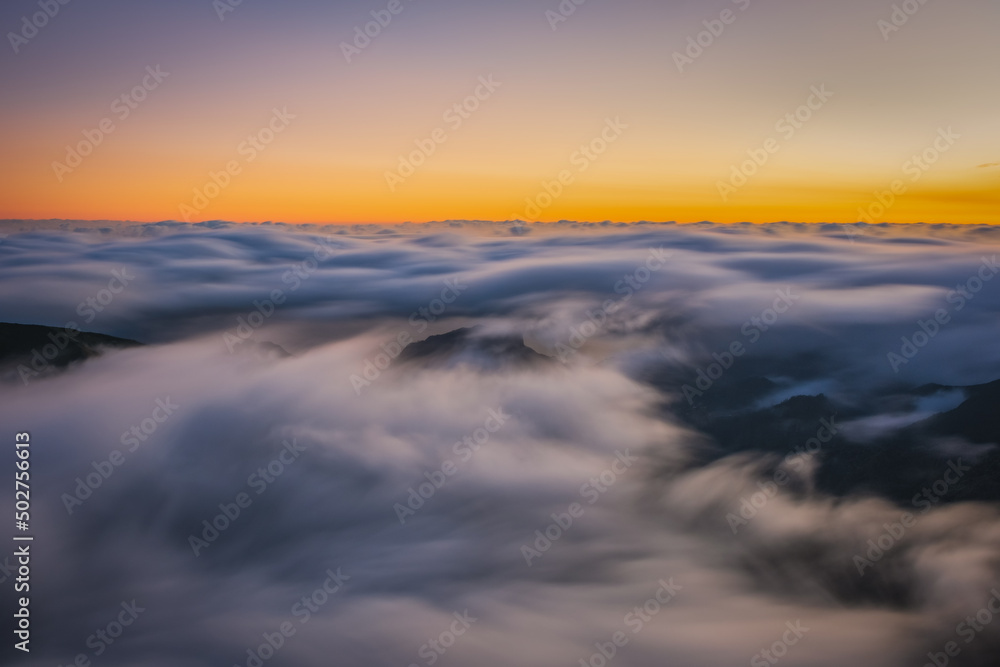 Mountain trail Pico do Arieiro, Madeira Island, Portugal Scenic view of steep and beautiful mountains and clouds during sunrise. October 2021. Long exposure picture