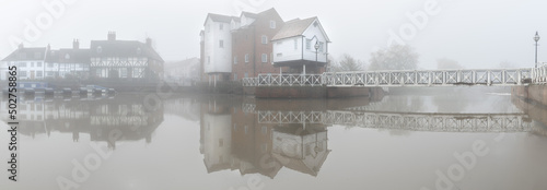Abbey Mill Tewkesbury - A misty morning adding mood and drama to the scene in this panorama looking across Mill Avon capturing the cottages, mill and their reflections..