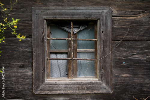 Croatia, May 01,2022 : Rustic style aged window at rural home wall.