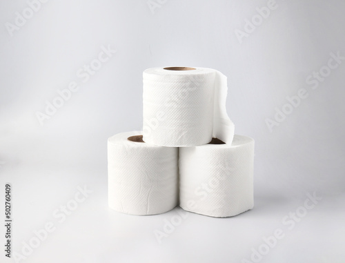 Rolls of toilet paper on light gray background.