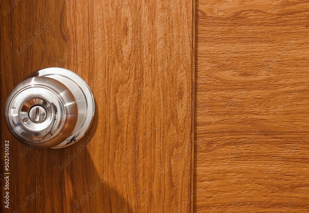 wooden door and stainless steel round ball door knob. - obrazy, fototapety, plakaty 