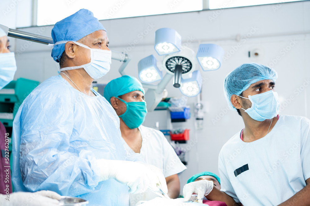 sugreon operating or doing surgery by looking at monitor at operation theater - concept of technology, development at healthcare and medical sugreon operating or doing surgery by looking at monitor at operation theater - concept of technology, development at healthcare and medical