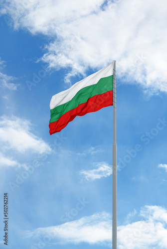 Flag of Bulgaria in front of blue sky and clouds