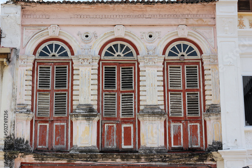 Beautiful arched windows on the exterior facade of an old building in the heritage town of Penang.