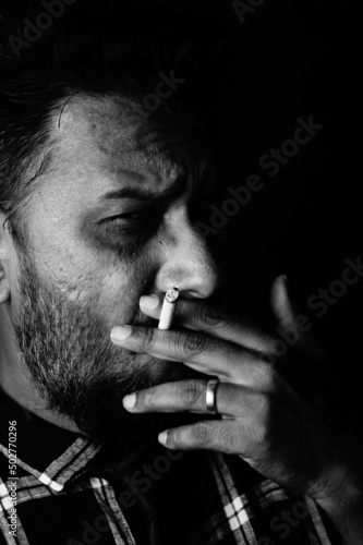 Angry man smoking cigarette