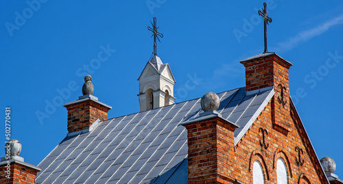 General view and close-up of architectural details of the sacred complex built in 1791, i.e. the belfry and the Catholic church of Saint John the Baptist in the town of Piski in Masovia in Poland. photo