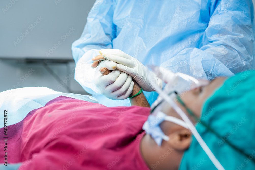 close up shot doctor at operation theatre consoling patient before operation - concept of trust, empathy and healthcare treatment close up shot doctor at operation theatre consoling patient before operation - concept of trust, empathy and healthcare treatment